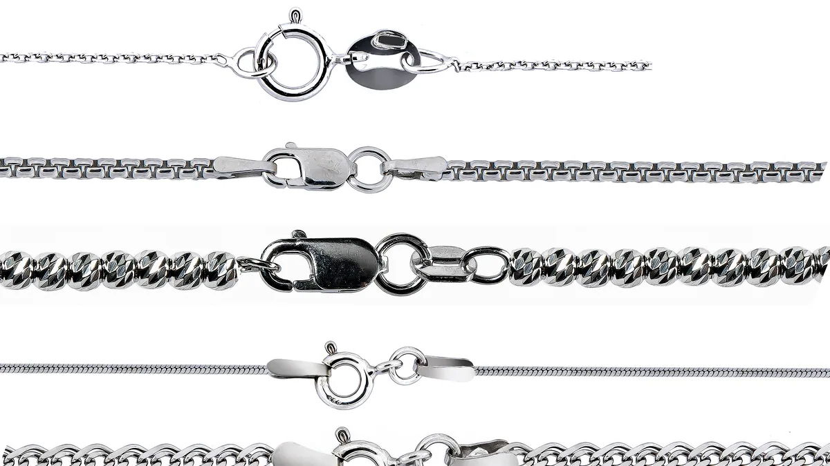 A short stretch of silver chain with a small lobster clasp at each end, laid flat on a dark surface.